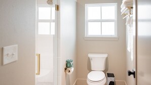 A small bathroom with a toilet, a window, and a towel rack. - Gloria Inn Unit 5 -5 minutes from Baylor and 2 Blocks to Magnolia (Waco)