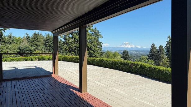 A covered outdoor area with a view of a mountain and trees. - 2 acres lot with Mt Rainier view (Edgewood)