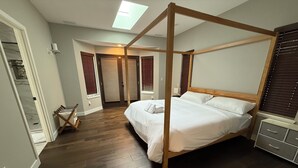 A bedroom with a four-poster bed, wooden flooring, a skylight, and a walk-in closet. - 2 acres lot with Mt Rainier view (Edgewood)