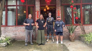 A group of people standing in front of a restaurant named "NINHO RETREAT." - Ninh Hoa Retreat (Tay Hoa Lu)