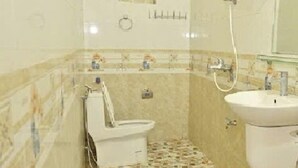 A small bathroom with a toilet, sink, and shower. - Ninh Hoa Retreat (Tay Hoa Lu)