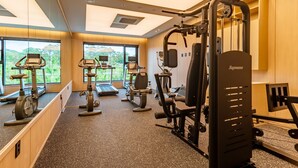 A gym with cardio machines, weightlifting equipment, and a treadmill. - HOUNDHOTELDAEGUHYUKSIN (Daegu)