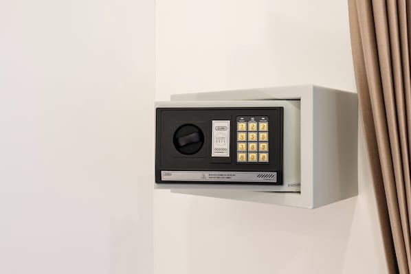 A wall-mounted electronic safe with a keypad and a lock. - Eden Extend Fisherman Village (Koh Samui)