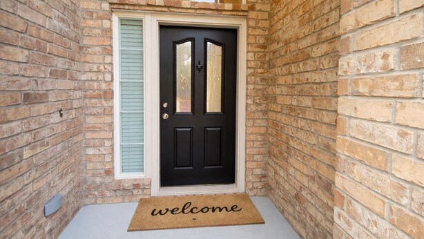A black door with a glass panel and a welcome mat in front. - Crew Base | Bunk Beds •Pool Table •Parking• Yard (Frisco)
