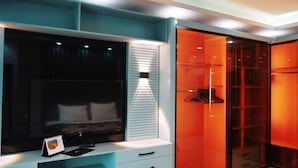 A modern bedroom with a bed, a desk with a calendar, and a wardrobe with a mirror. - Premium Swiss Residence Agouza (Giza)