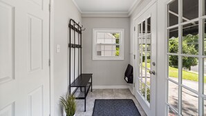 A hallway with a bench, a coat rack, a door, and a window. - Perfect Lindley Park location - Minutes from GAC, Coliseum, Restaurants and Pubs (Greensboro)