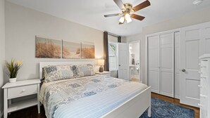 A bedroom with a bed, nightstands, a ceiling fan, artwork, a closet, and a window. - Perfect Lindley Park location - Minutes from GAC, Coliseum, Restaurants and Pubs (Greensboro)