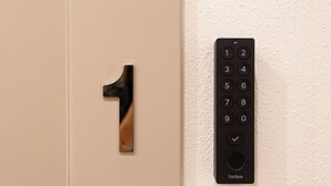 A door with a large number '1' and a wall-mounted keypad with numbers 1-0 and a checkmark symbol. - Elegance and Relaxation in the center of Cagliari - King Standard (Cagliari)