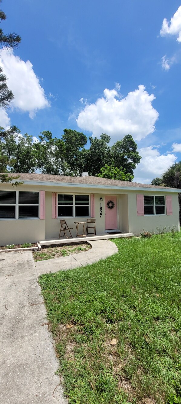 A single-story house with a front porch, a door with a wreath, and a number '1827' on the door. - 3 bedroom 1 bath house in the McGregor Corridor in Fort Myers (Fort Myers)