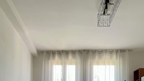 A living room with a beige sectional sofa, a round coffee table, and a potted plant. - Jaris Apartment (Vicenza)