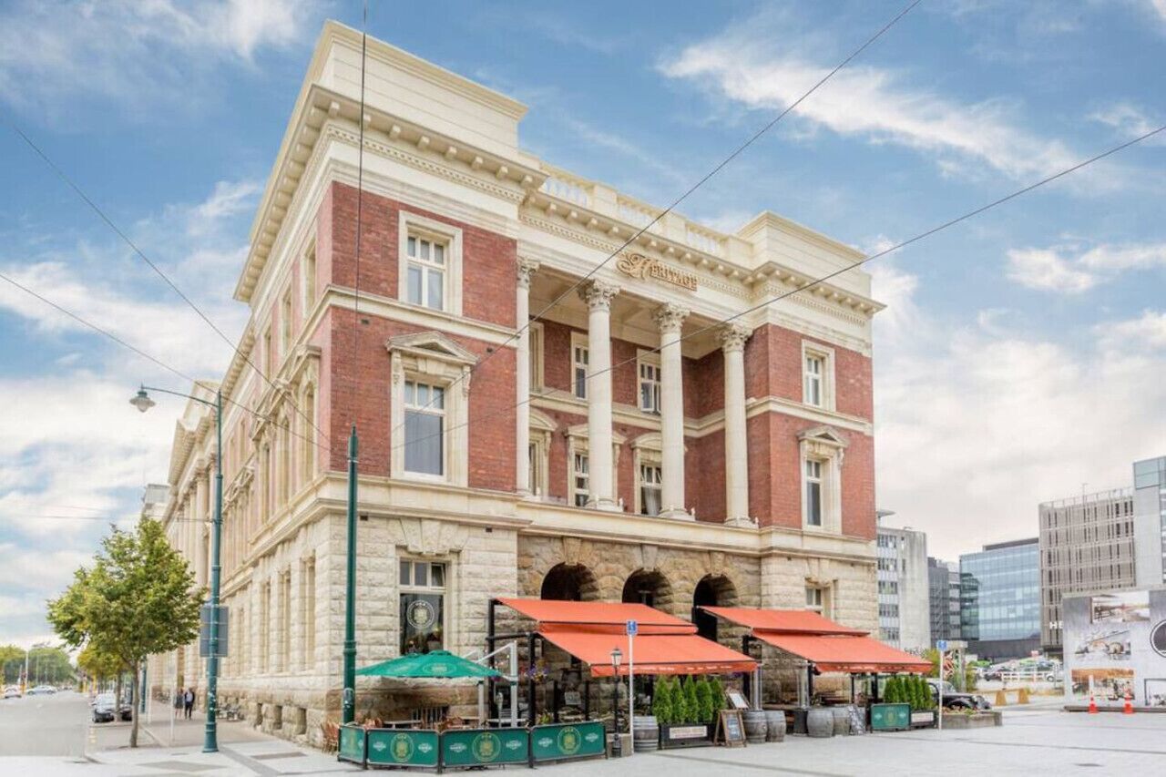 A historic building with a classical facade, large windows, and a prominent entrance.