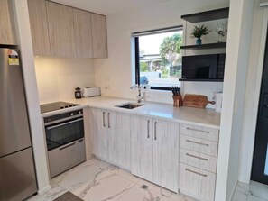 Microwave, stovetop, dishwasher, cookware/dishes/utensils