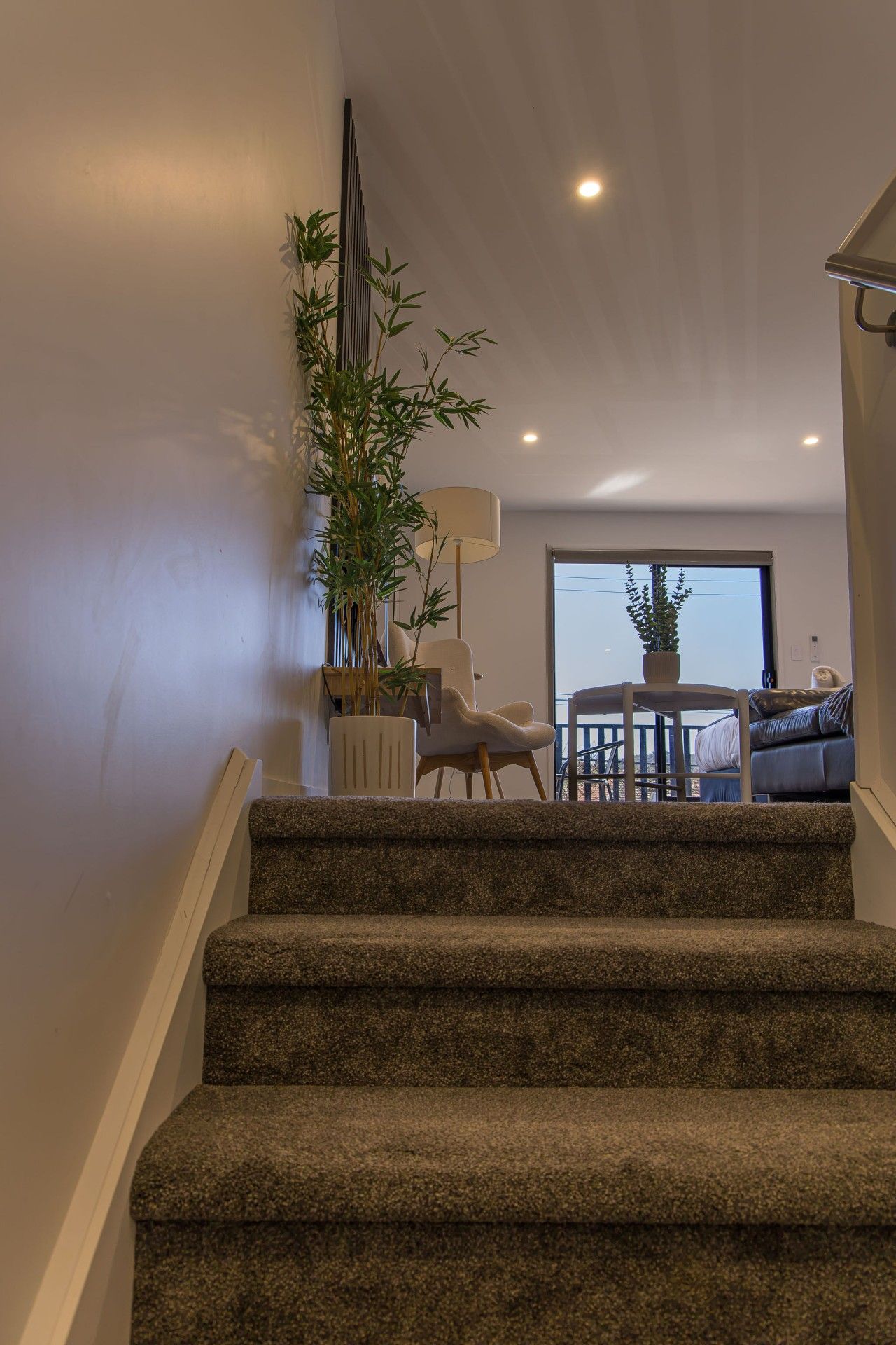 A staircase leading to a living area with a view of the outdoors.