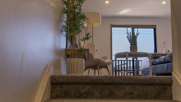 A staircase leading to a living area with a view of the outdoors.