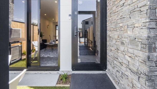 A modern building with a stone facade and a glass door entrance. - Ariki Shire: A Wellington Fantasy (Lower Hutt)