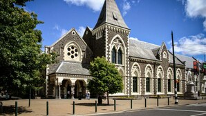 A historic building with arched windows and a prominent tower.