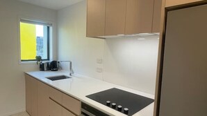 A modern kitchen with a built-in stove, oven, and sink.