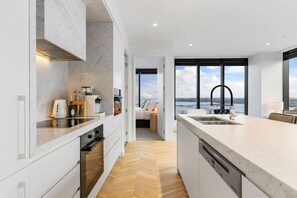 Fridge, stovetop, dishwasher, coffee/tea maker