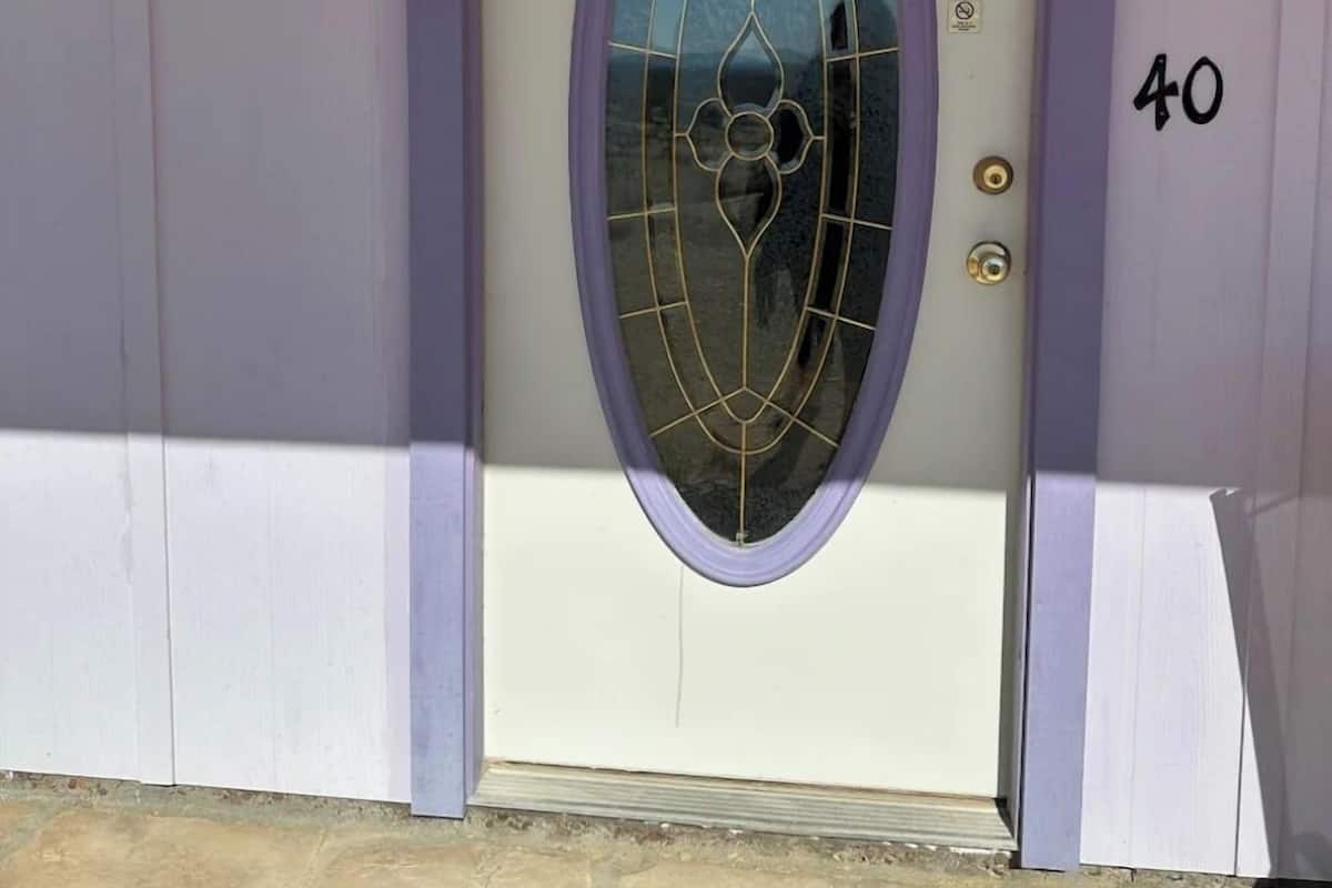 A door with a purple frame and a glass panel, marked with the number 40.