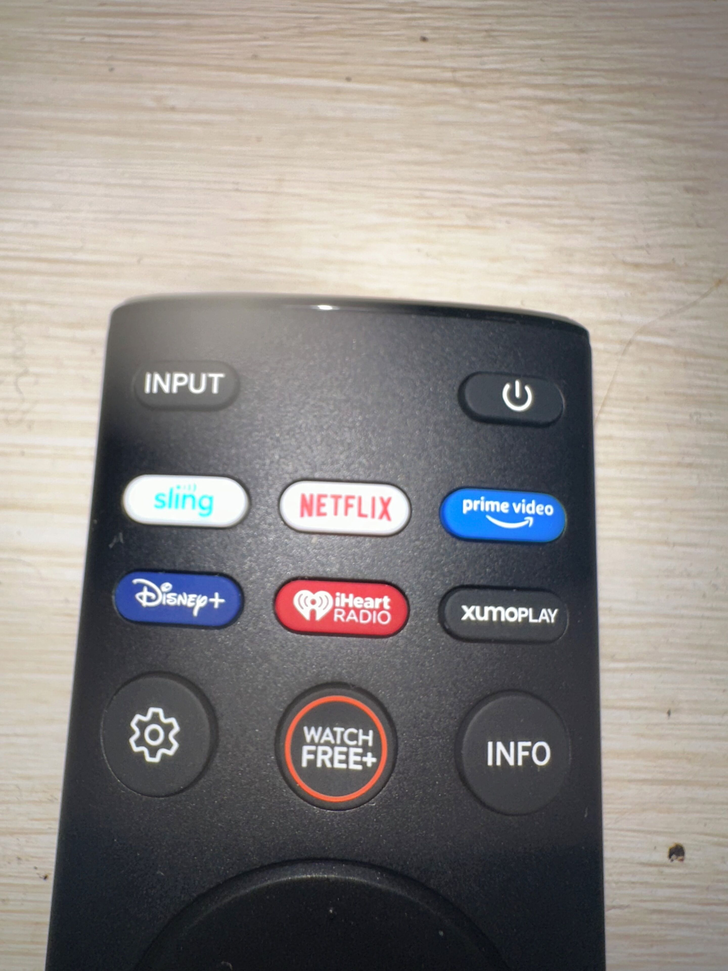 A remote control with various buttons including input, sling, Netflix, prime video, Disney+, iHeart Radio, XMOPLAY, and watch free+.