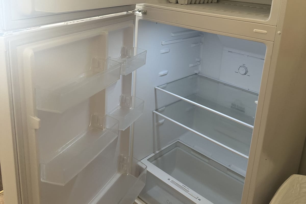 A refrigerator with multiple shelves and a freezer compartment.