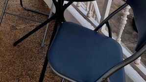 A balcony with a table and chairs, a small wooden box, and potted plants. - PERIPLO HOME (Camelle)