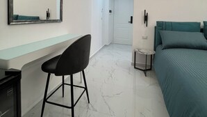 A modern bedroom with a bed, a desk, and a chair. - Napoli Heart and Suite (Naples)