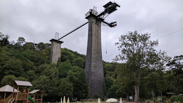 A park with picnic tables, a playground, and a large windmill structure.