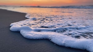 A beach with waves gently lapping onto the shore. - Pet-Friendly Ocean Lakes 4BR | 2 Golf Carts | Sleeps 10 | Large Lot (Myrtle Beach)