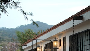 A house with a patio, outdoor lighting, and a view of the hills.