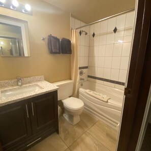 Bathtub, towels, soap, shampoo