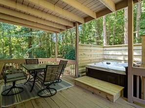 An outdoor deck with a hot tub, wooden deck, and a table with chairs. - South Asheville Holiday Haven: 2 Kings & 2 Queens! (Royal Pines)