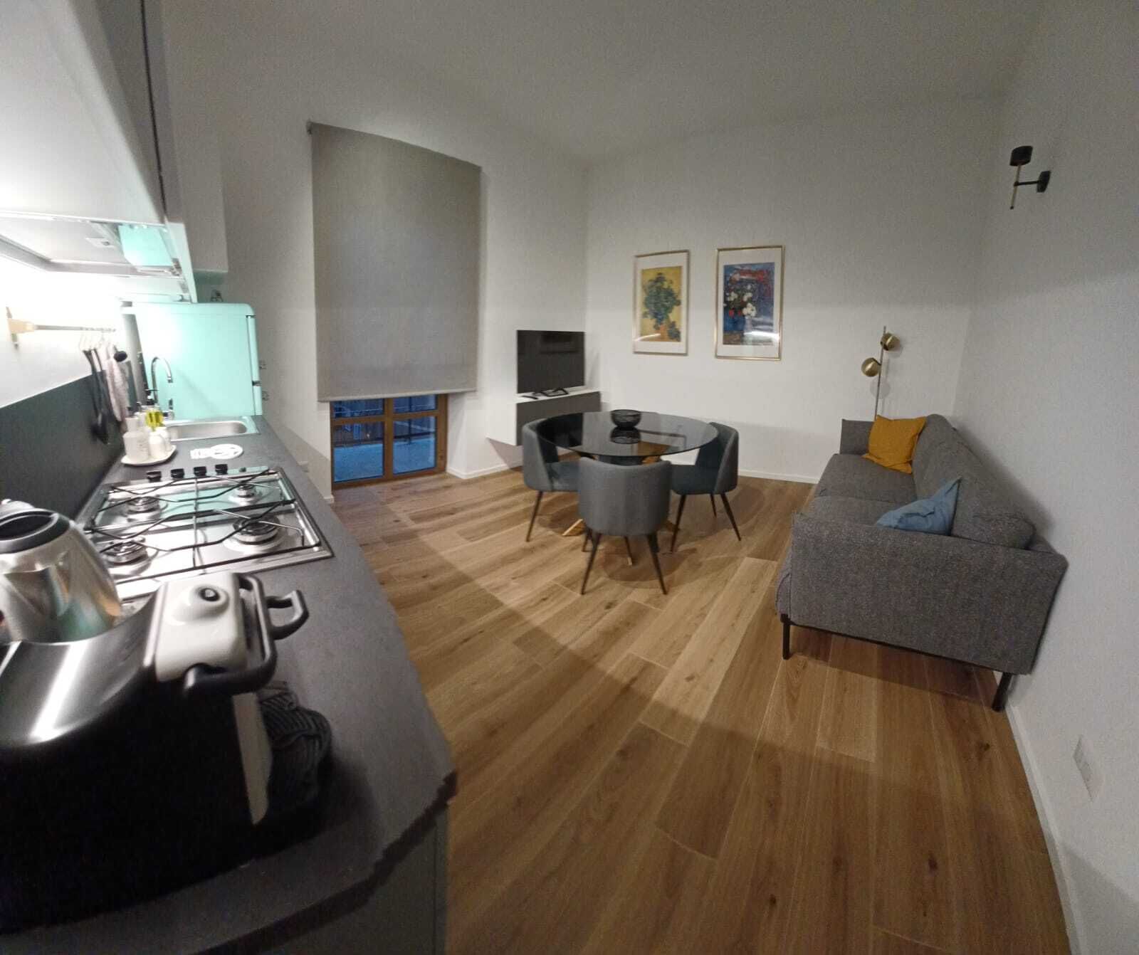 A compact living space with a kitchen, dining area, and seating area.