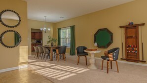 A spacious living room with a dining area, a pool table, and a billiards cabinet. - Spacious Gem Near Fort Moore  (Columbus)