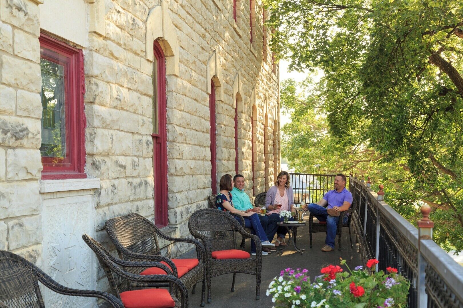 A stone building with a balcony seating area.