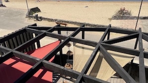 A beach view with a wooden deck structure.
