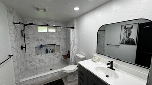 Shower, hair dryer, towels, toilet paper