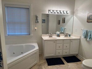 Jetted tub, hair dryer, towels, toilet paper