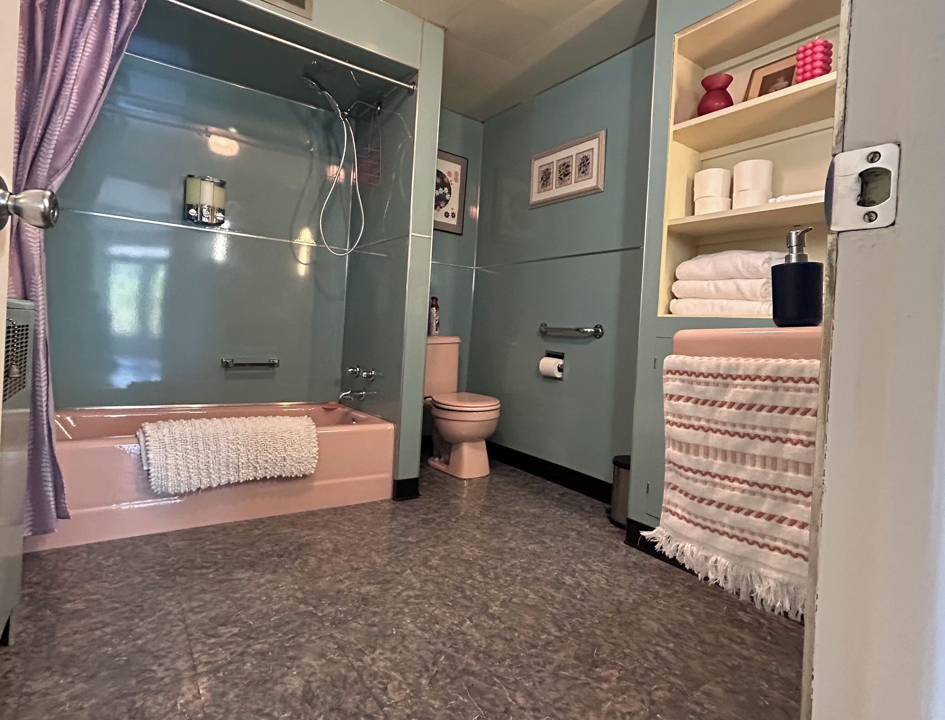 A bathroom with a bathtub, toilet, and shower.