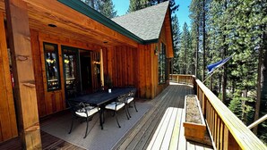 A wooden cabin with a deck, a dining table, and chairs. - Walk to Downtown Graeagle, Mill Pond & Pickleball (Graeagle)