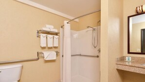 A bathroom with a toilet, a shower with a glass door, a towel rack with folded towels, and a sink with a mirror above it. - Sep 29- Oct 2, Historic Hotel 10 mins from AI Conference 2026, SF 1BR/2BA, (San Francisco)