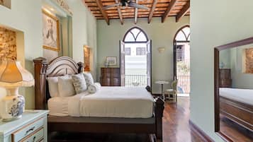 A bedroom with a bed, a nightstand, a lamp, a dresser, and a ceiling fan.