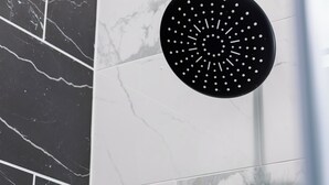 A black circular object with white dots on a tiled wall. - Charming -Cozy private studio Bedroom! (Dallas)