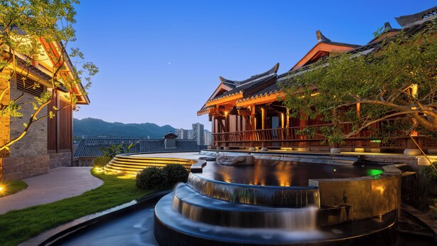 A traditional building with a water feature in front. - Yueyin Chongqing Courtyard (Chongqing)