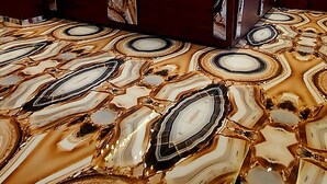 A hotel lobby with a marble-patterned floor, a reception desk, and modern lighting fixtures. - Hotel madhuban  (Silvassa)