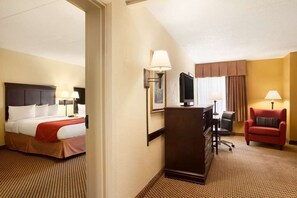 A hotel room with a bed, desk, chair, and a television. - Wingate by Wyndham Jacksonville FL (Jacksonville)