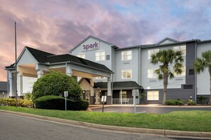 A hotel with a 'Spark by Hilton' sign, a covered entrance, and a parking lot. - Spark by Hilton St. Augustine I 95 (St. Augustine)