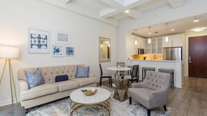 A modern living room with a sofa, armchairs, a coffee table, and artwork on the walls. - Constellations Elegant 1 BR in Downtown Houston (Houston)