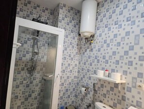 Shower, hair dryer, towels, toilet paper