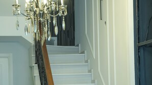 Eine Treppe mit weißen Stufen, einem Holzgeländer und einem schwarzen Geländer.
